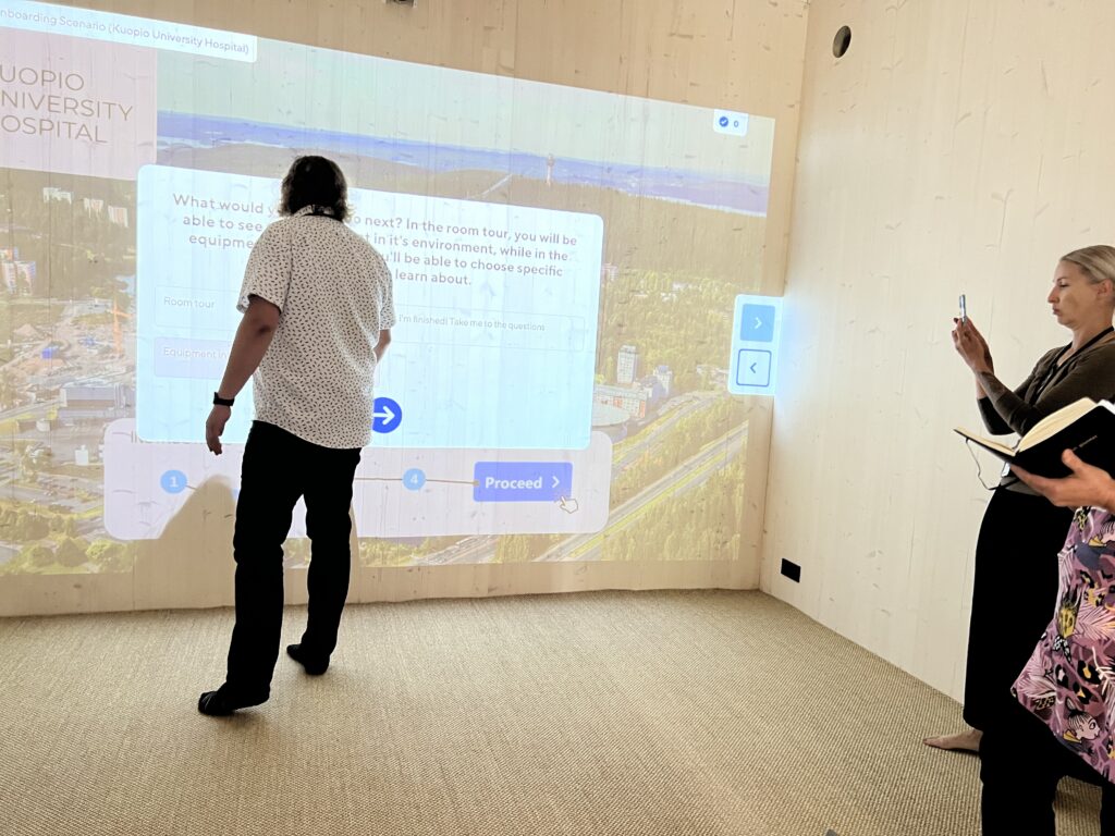 Vocational college teachers exploring an interactive training scenario in a shared immersive demo room at ThingLink office